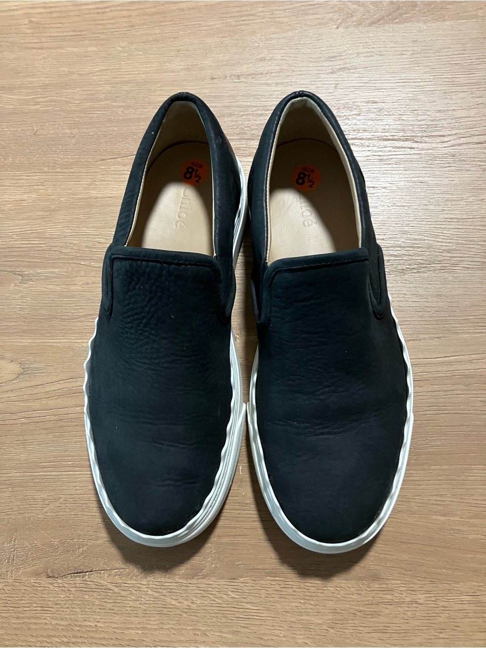 Chloe Black Slip-On Leather Sneakers with Scalloped White Sole